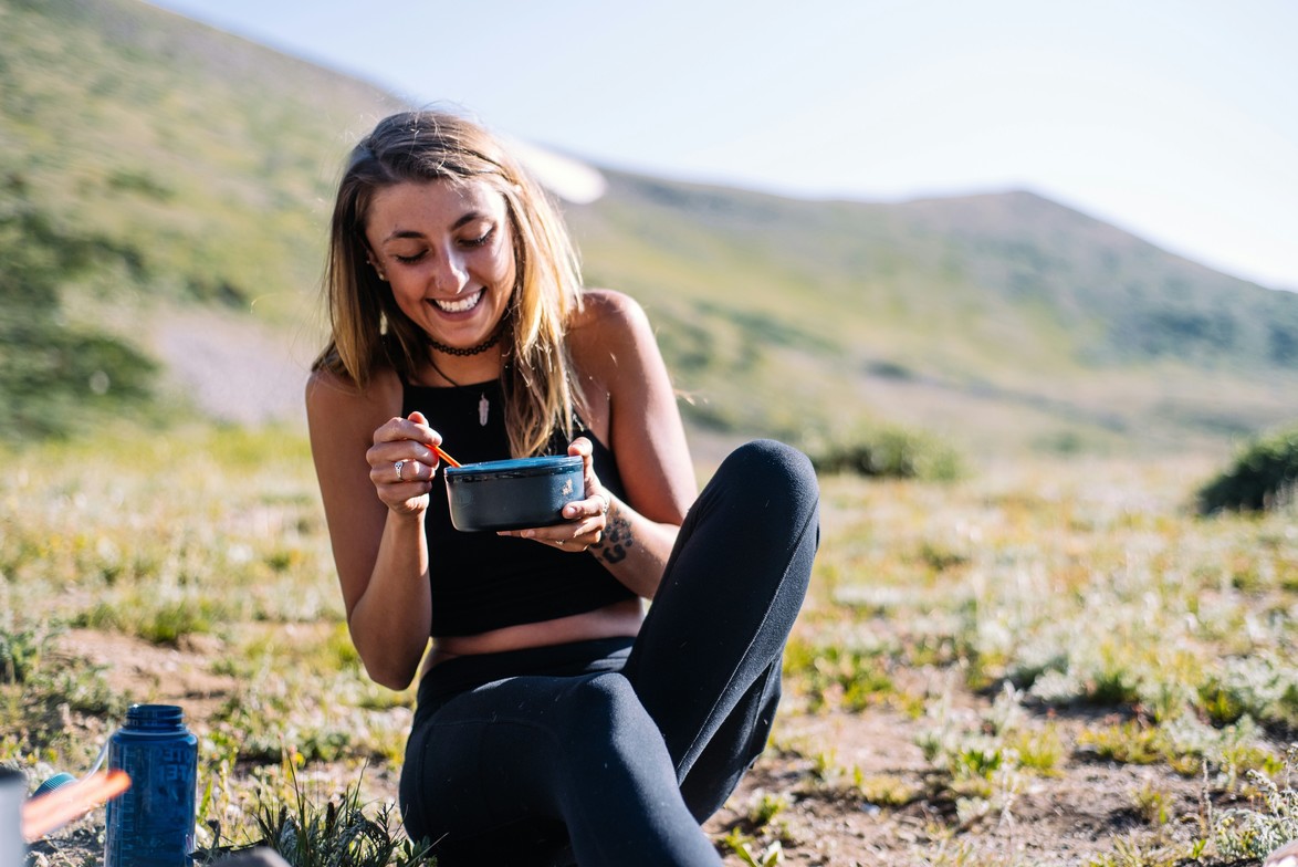 Woman happy eating from bowel of food healthy eating